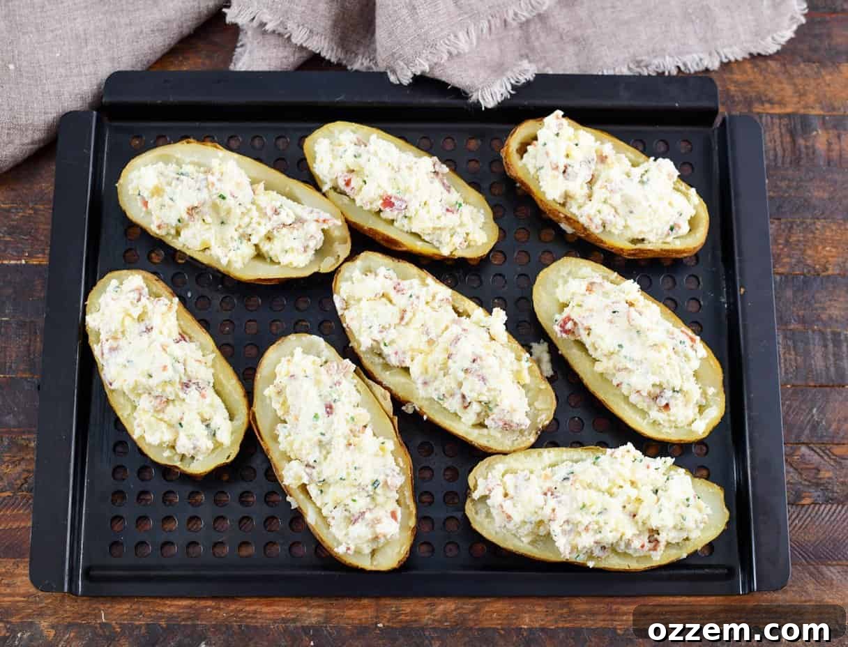 Smoky Creamy Twice Baked Potatoes 11 cooked potatoes with filling on a tray