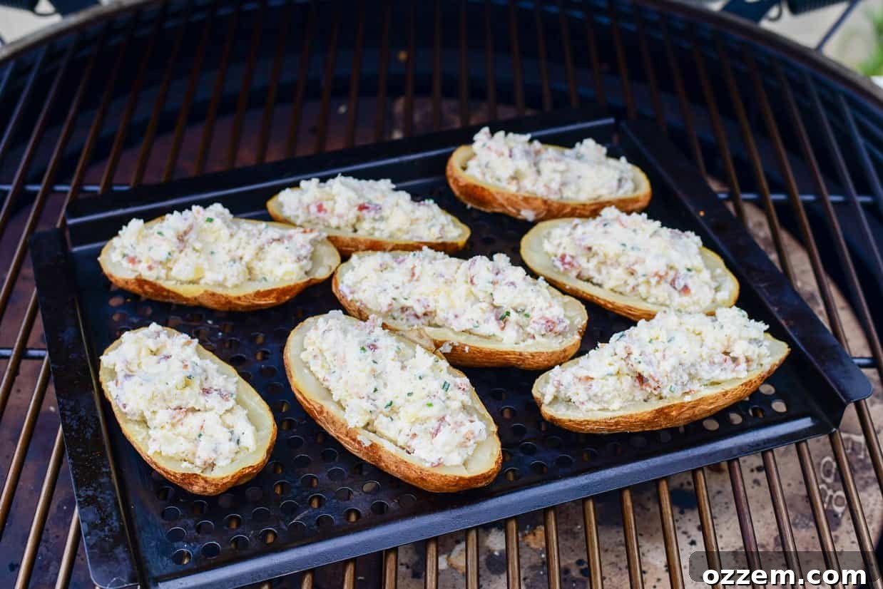 Smoky Creamy Twice Baked Potatoes 12 twice smoked baked potatoes on a metal tray in a smoker