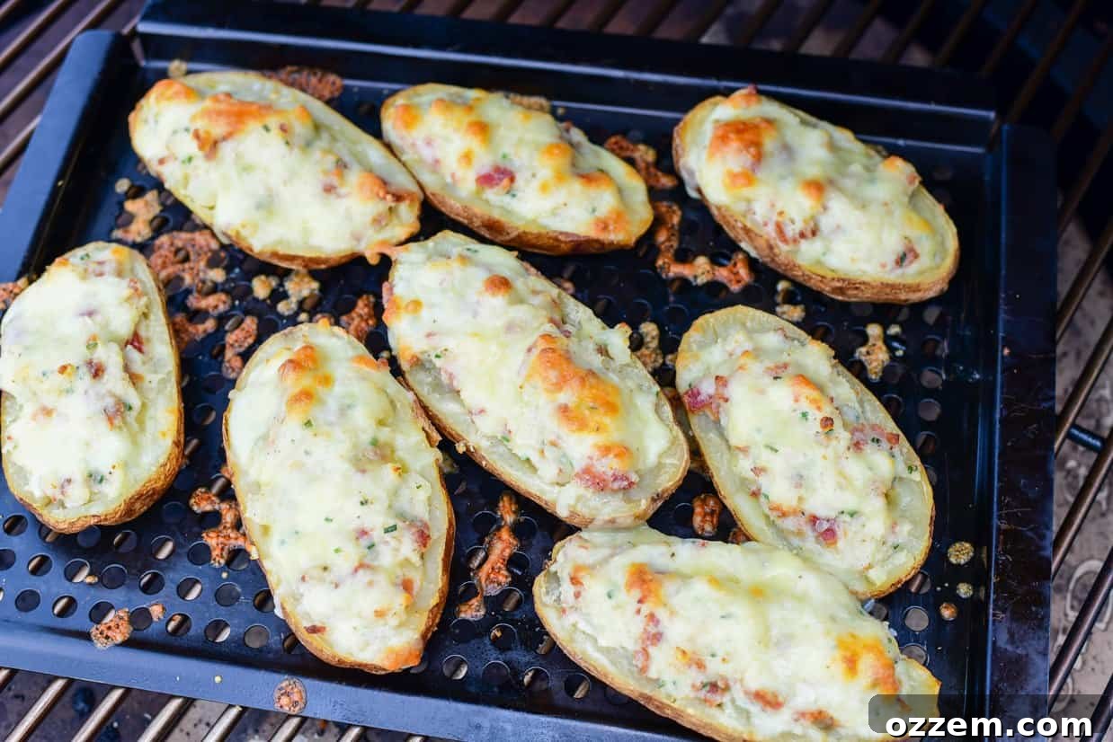 Smoky Creamy Twice Baked Potatoes 13 twice smoked baked potatoes on a metal tray in a smoker