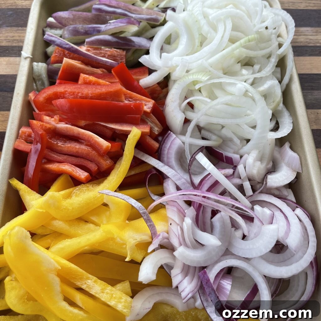 Sizzling Chicken and Steak Fajitas 3 Prepped chicken thighs, flank steak, and colorful bell peppers ready for the grill
