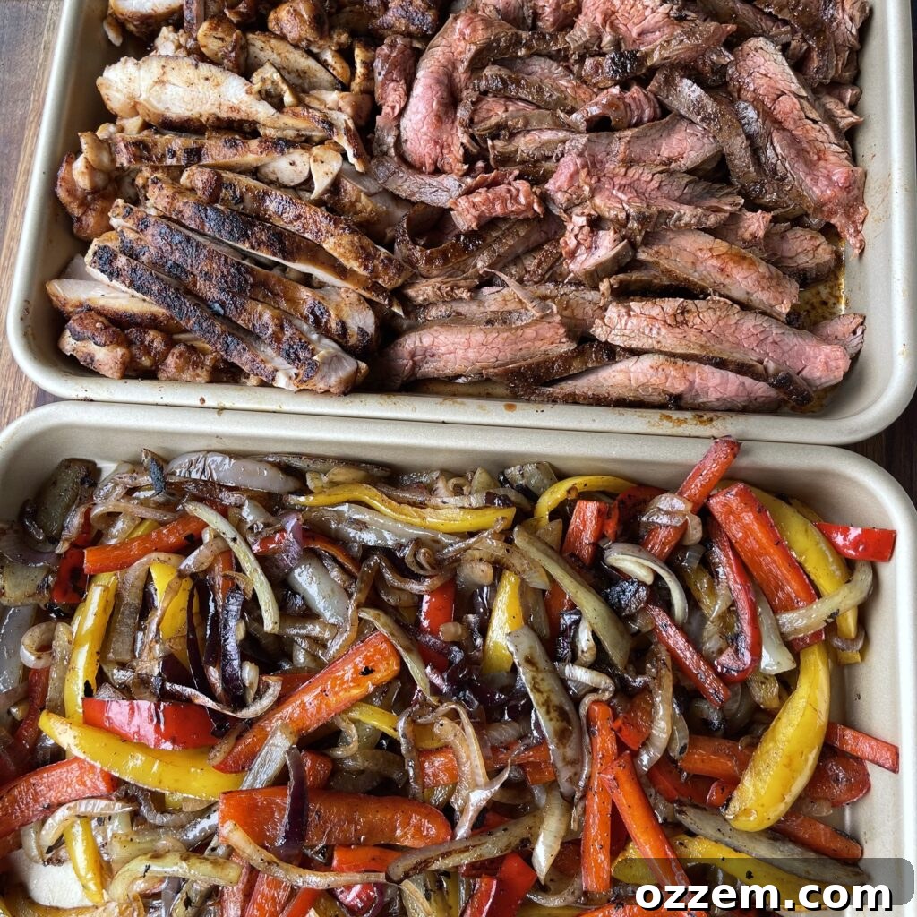 Sizzling Chicken and Steak Fajitas 5 Fajitas cooking on a large griddle with chicken, steak, peppers, and onions
