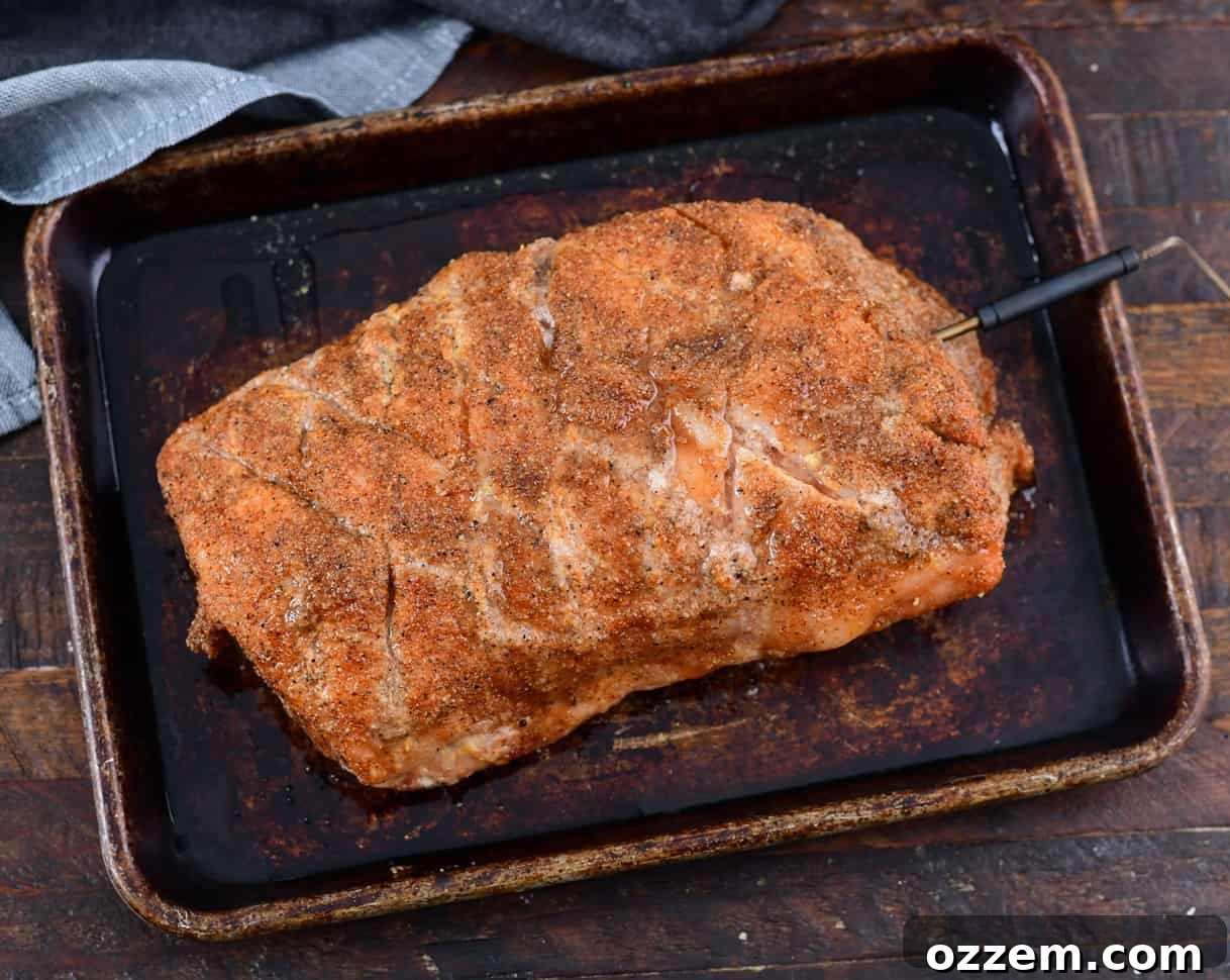 Wood-Fired Pork Loin Perfection 13 A probe thermometer inserted into the thickest part of the pork loin.