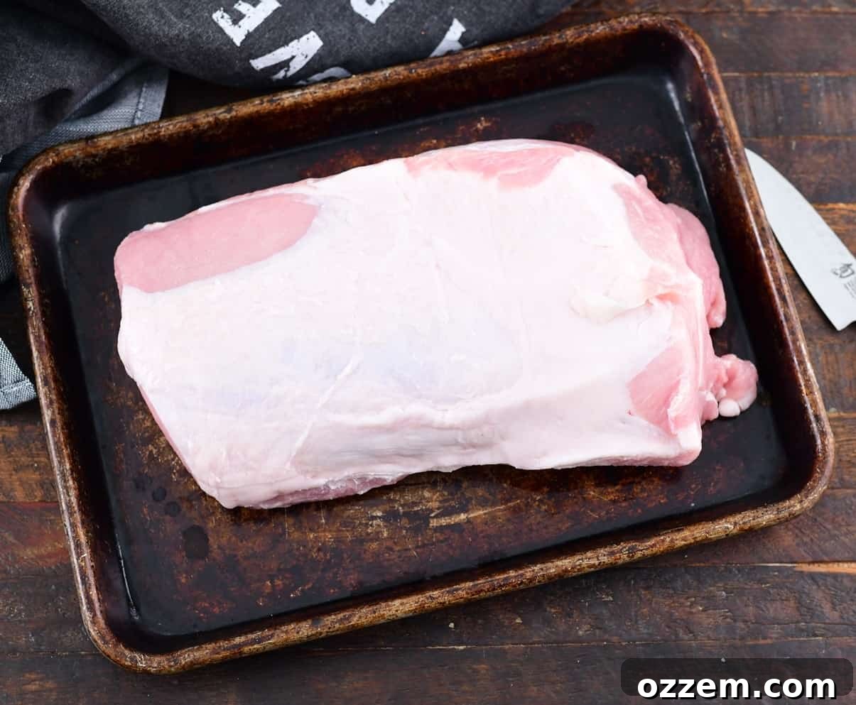 Wood-Fired Pork Loin Perfection 4 Rinsing and patting dry a pork loin to remove excess moisture.
