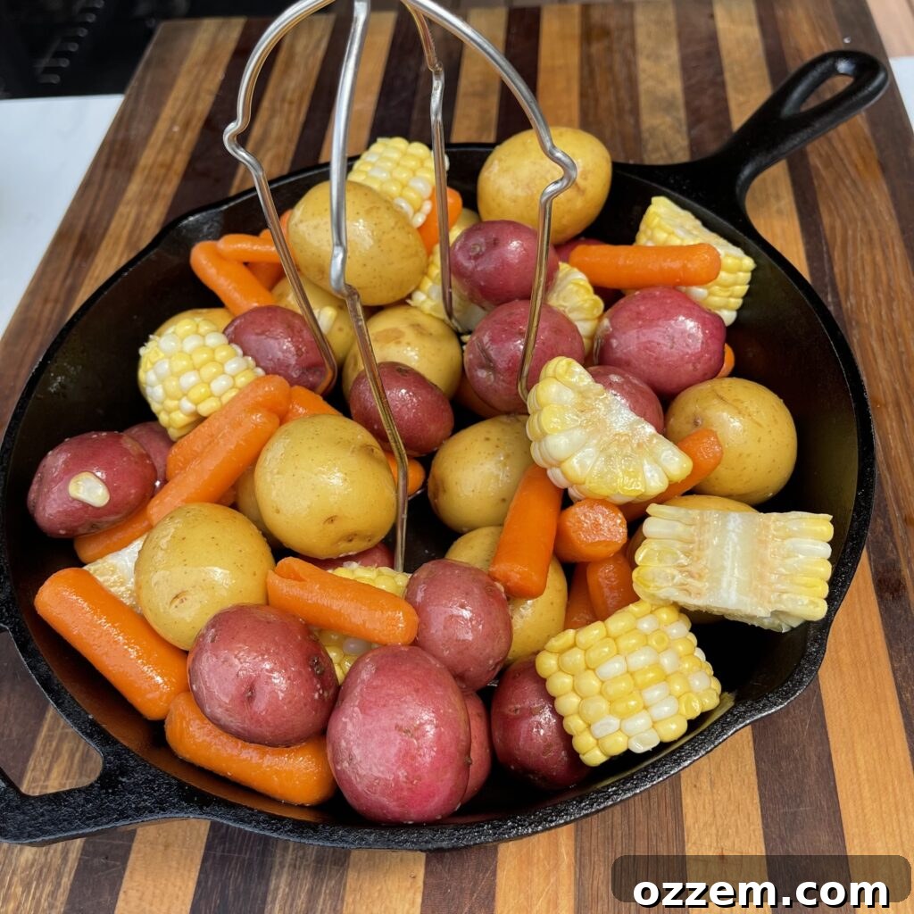 Seasoned mixed vegetables in a cast iron skillet with a chicken stand in the center, ready for the chicken.
