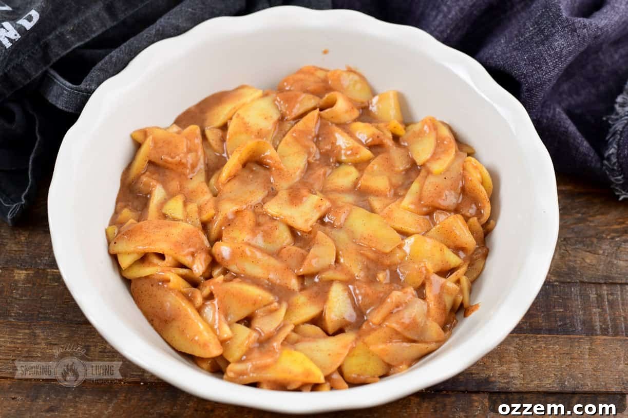 Assembling apple crisp in a pie dish