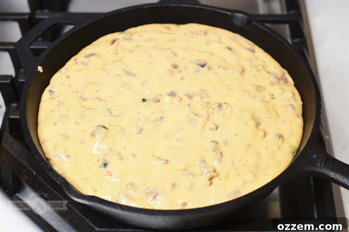 Campfire Queso Dip 14 A close-up of non-smoked queso dip, highlighting its creamy, rich texture before the smoky finish.