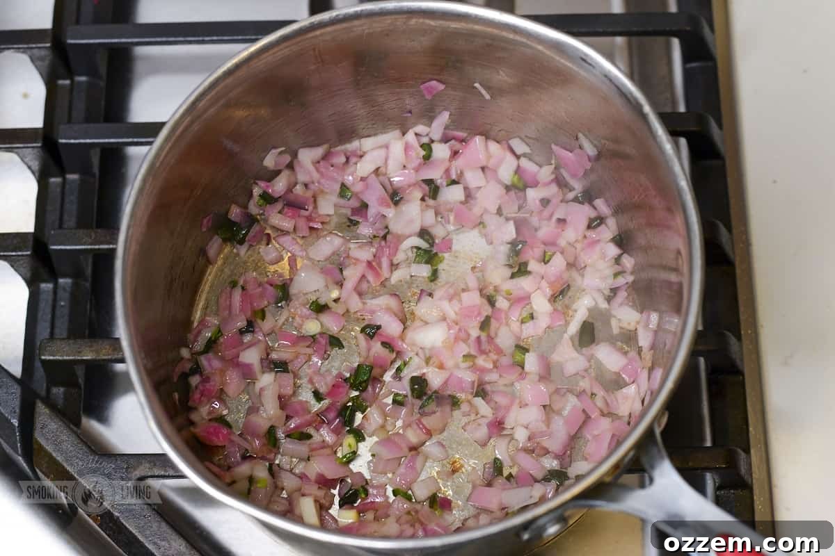 Campfire Queso Dip 6 Finely diced smoked vegetables cooking in a large saucepan with a bit of oil, beginning to brown, ready for flour.