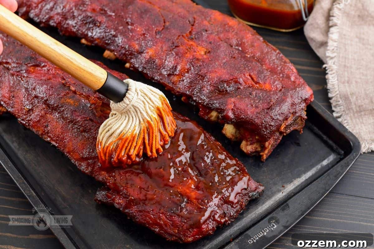 adding more BBQ sauce to finished 321 ribs