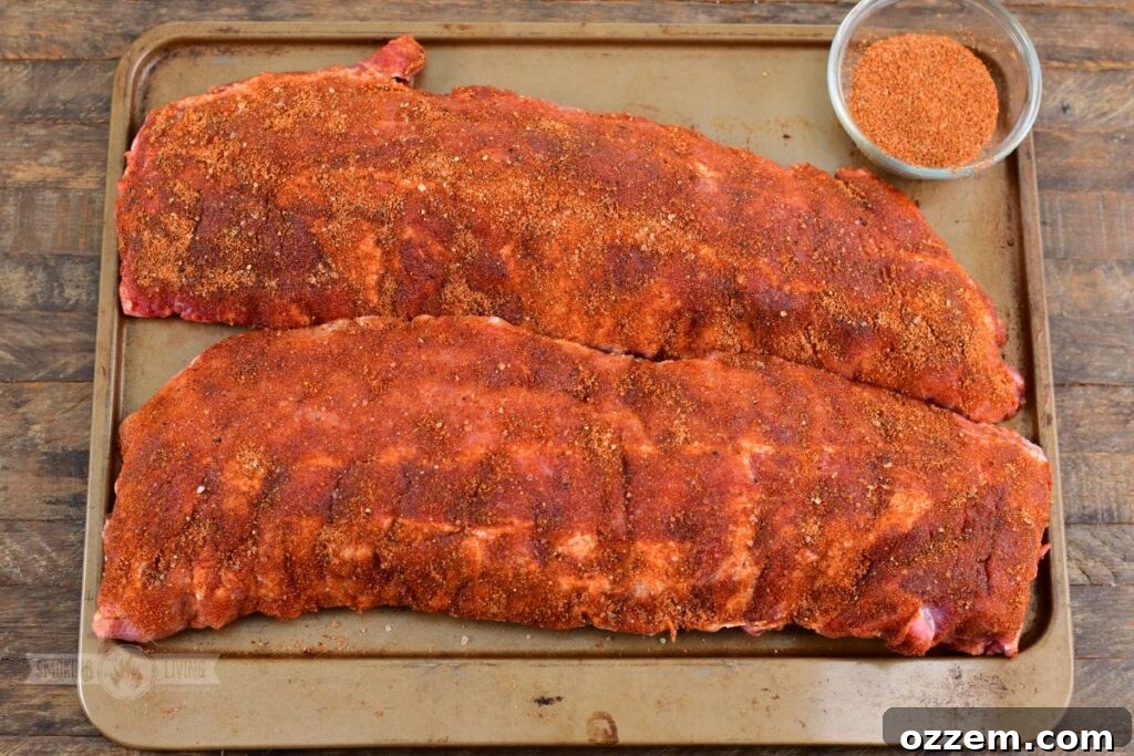 321 ribs generously covered in dry rub, ready for smoking