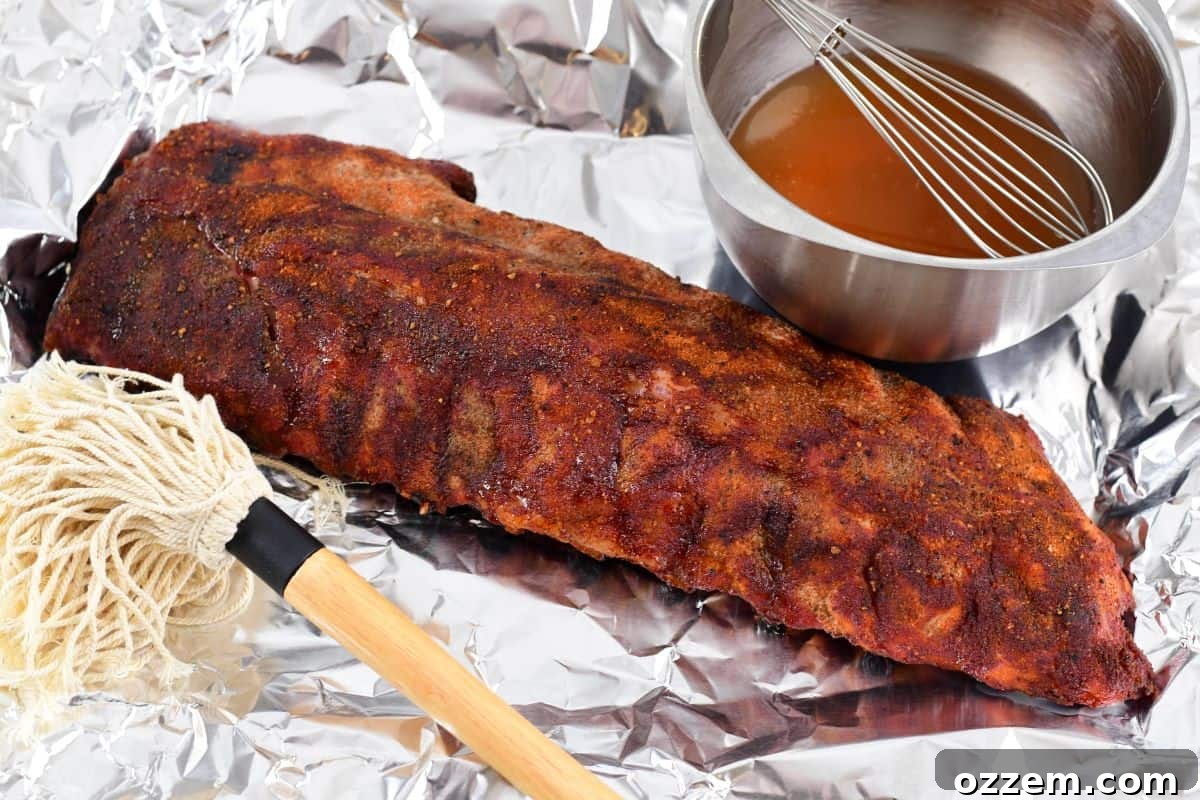 321 ribs being basted with mop sauce
