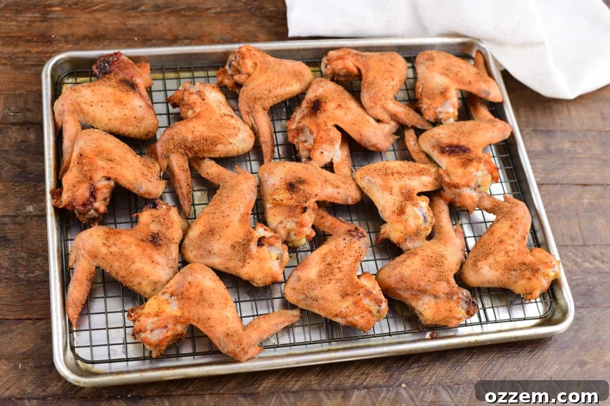 Smoked wings on a sheet tray after being broiled.