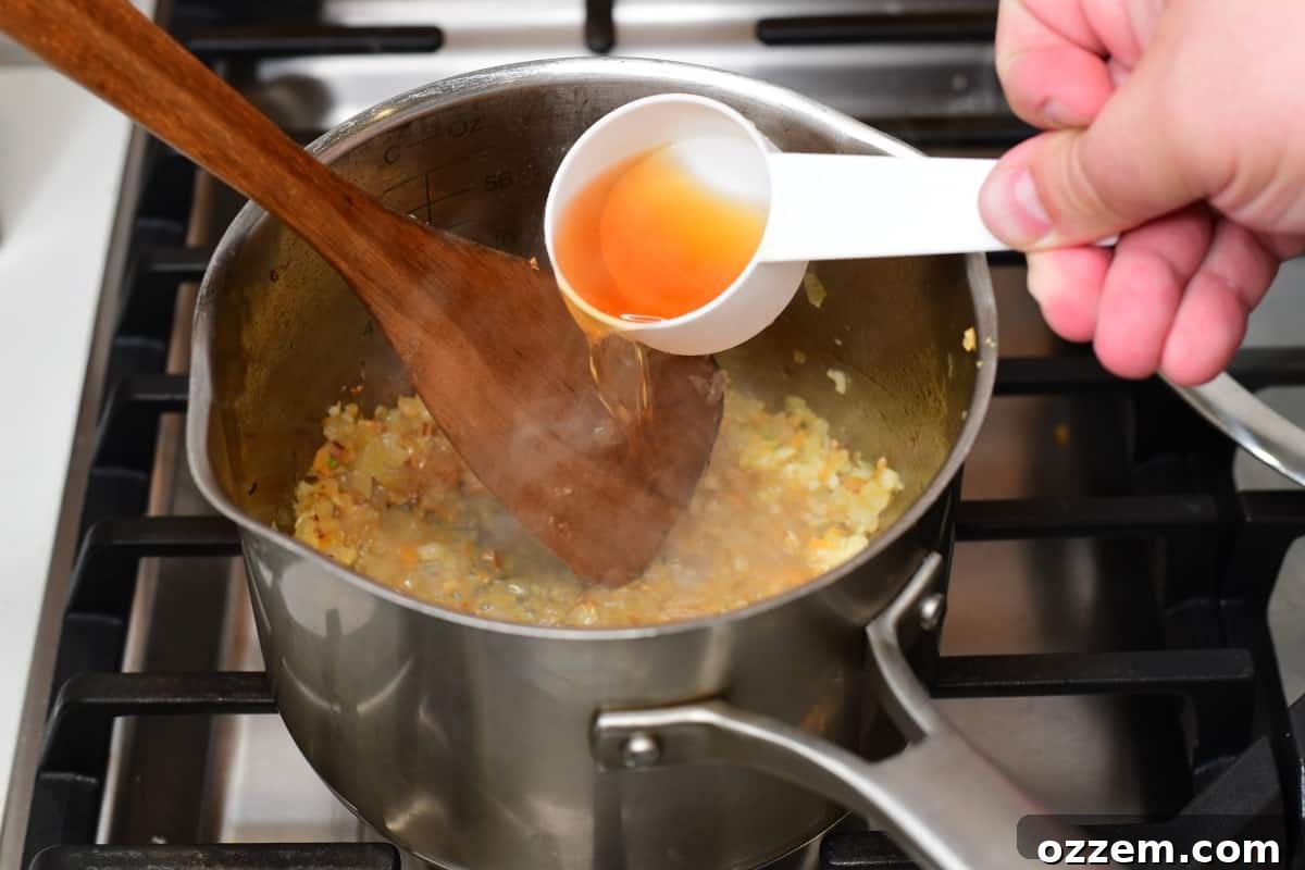 Bourbon being added to sauce mixture for cooking.