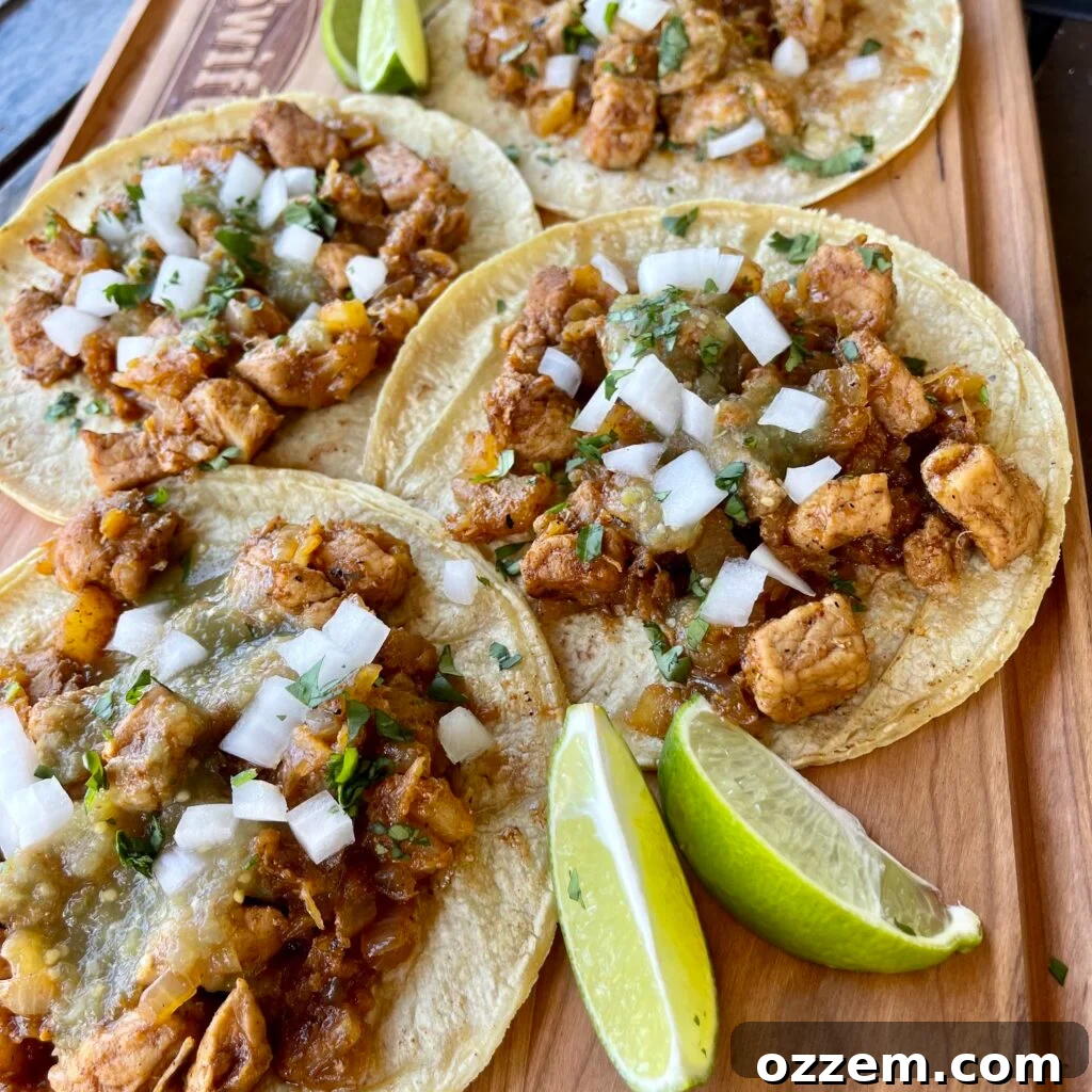 Effortless Pork Tacos 2 Close-up of freshly cooked Al Pastor style pork tacos with pineapple, onions, and cilantro