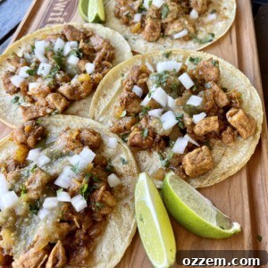 A plate of Easy Pork Tacos garnished with fresh cilantro and lime