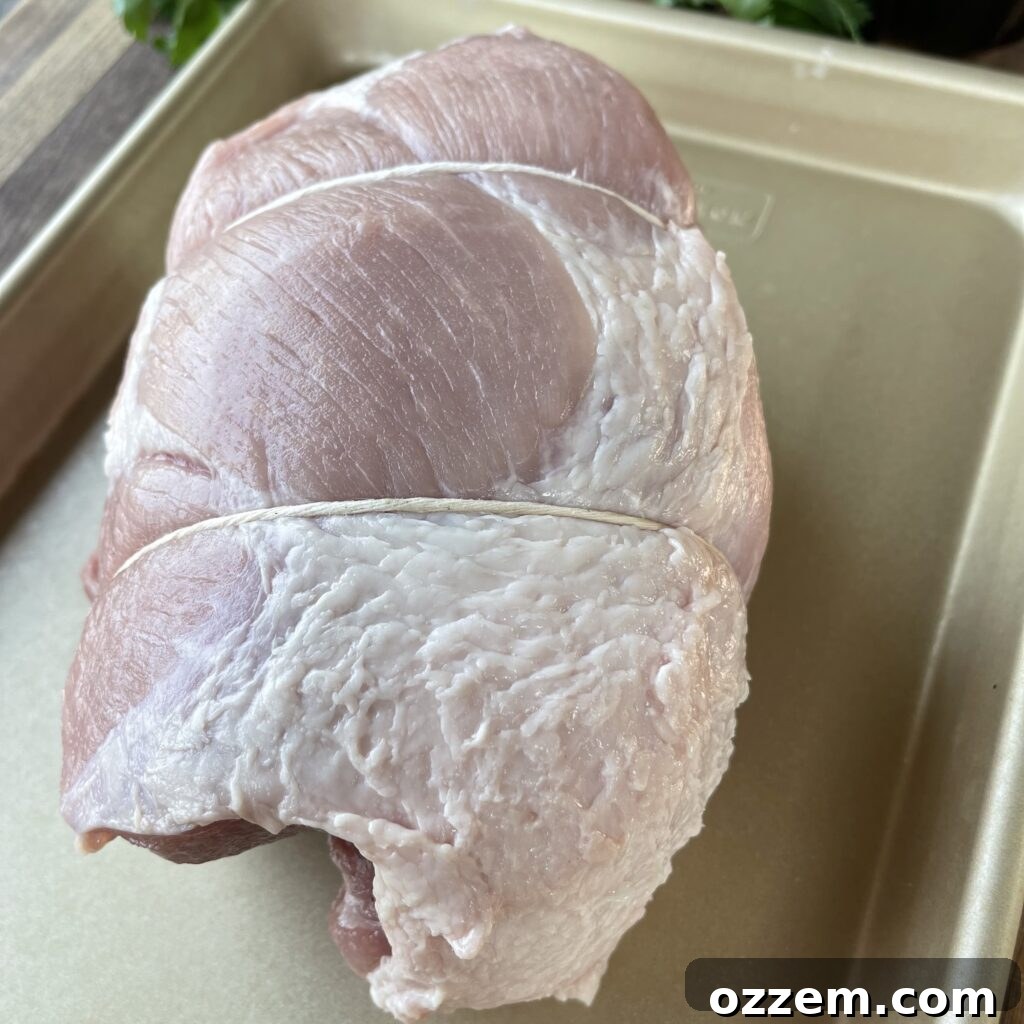 Petite shoulder pork roast covered in yellow mustard and BBQ rub