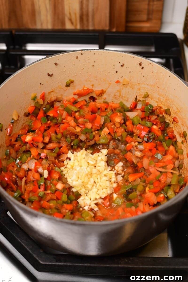 Garlic added to pot with veggies.