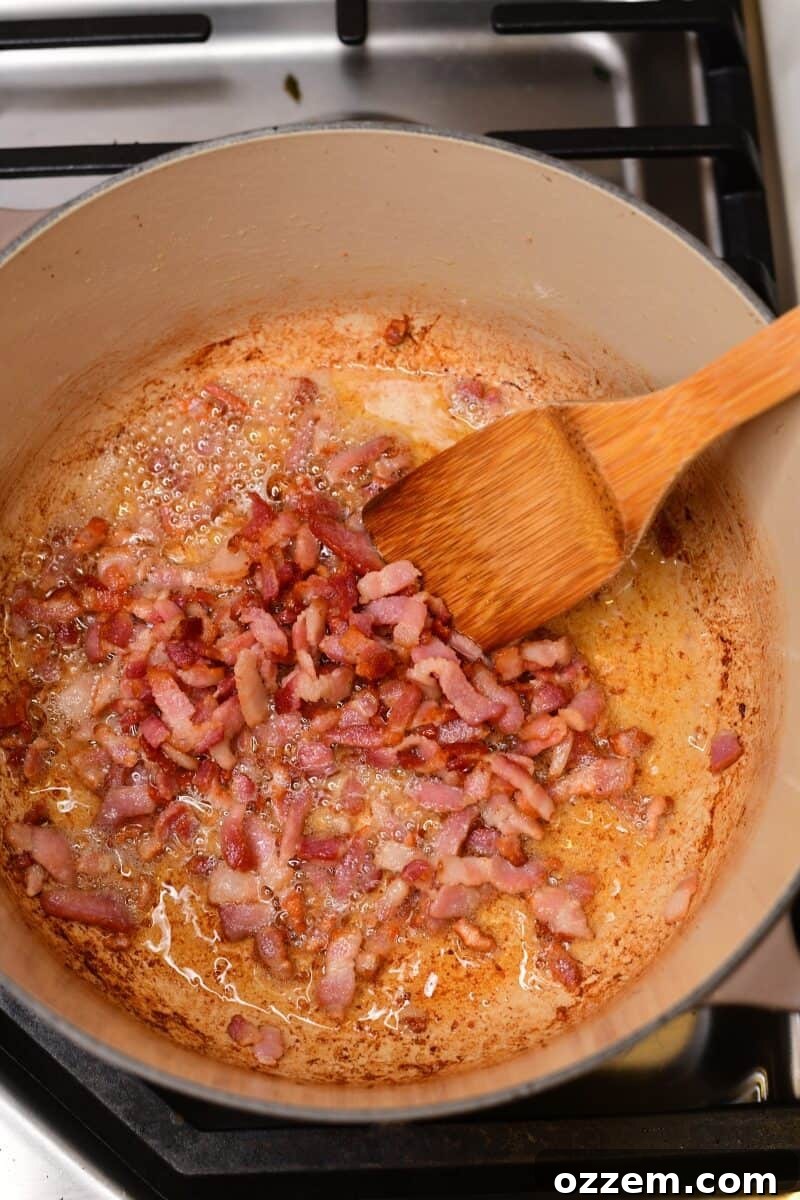 Bacon cooking in a pot on the stove