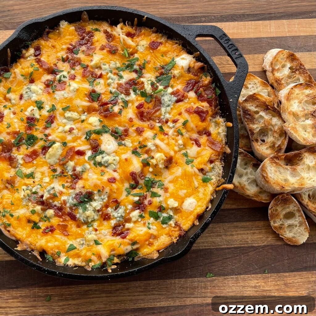 Smoky Chicken Dip 2 Delicious smoked chicken dip in a cast iron skillet, ready to be served at a tailgate party.