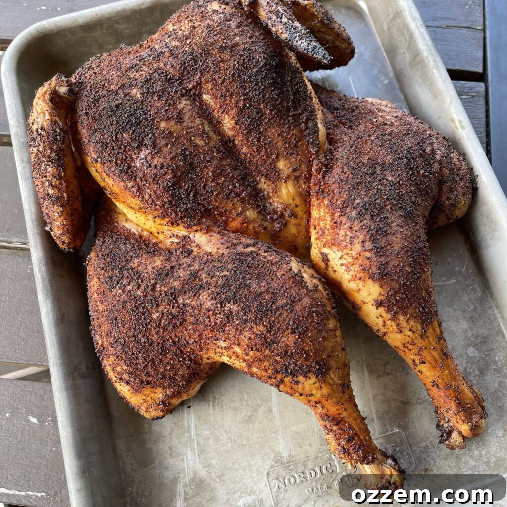 Smoky Chicken Dip 4 Spatchcocked chicken grilling indirectly on a smoker, achieving a beautiful golden-brown skin.