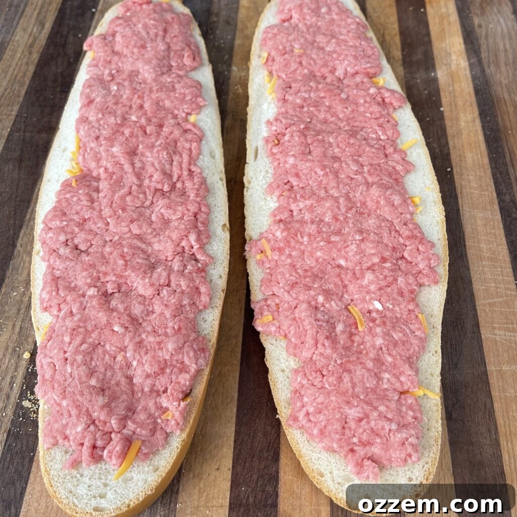 Mac Attack Toast 3 French bread loaf filled with shredded cheddar cheese and seasoned ground beef, ready for grilling