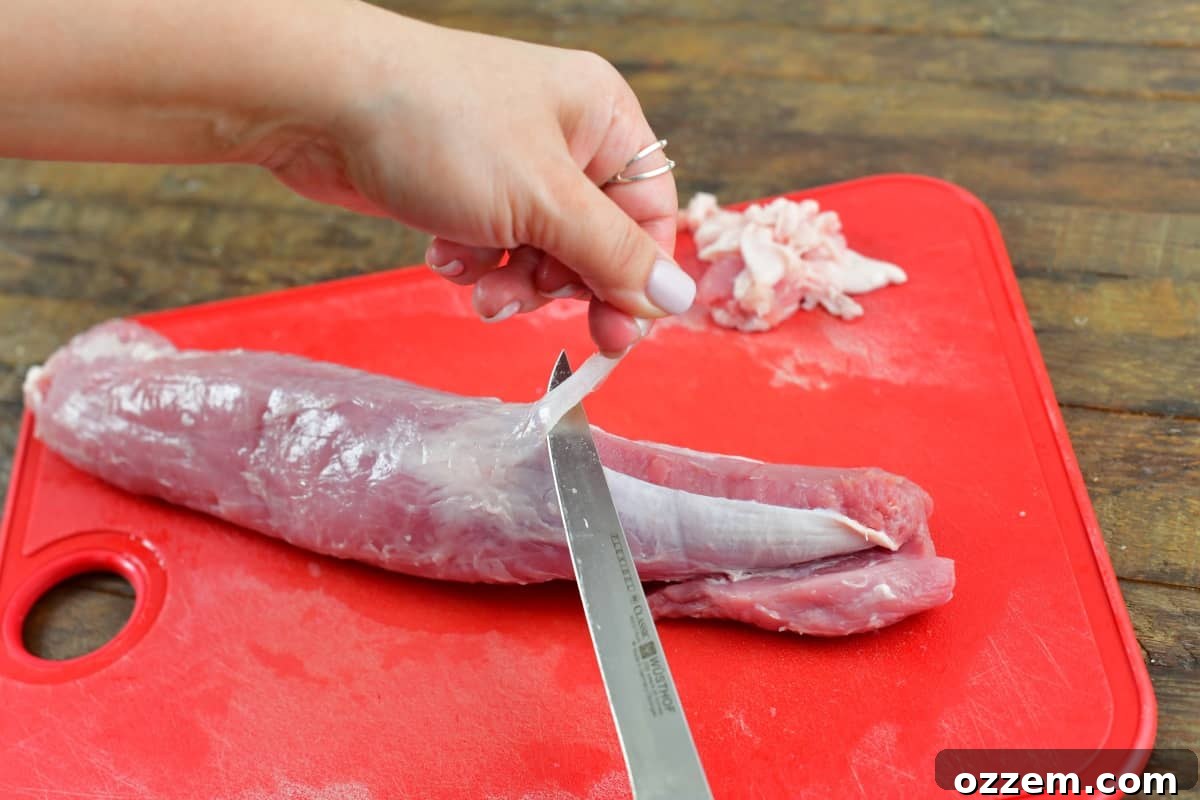 Slow-Smoked Pork Perfection 5 Trimming the silver off the pork tenderloin still raw