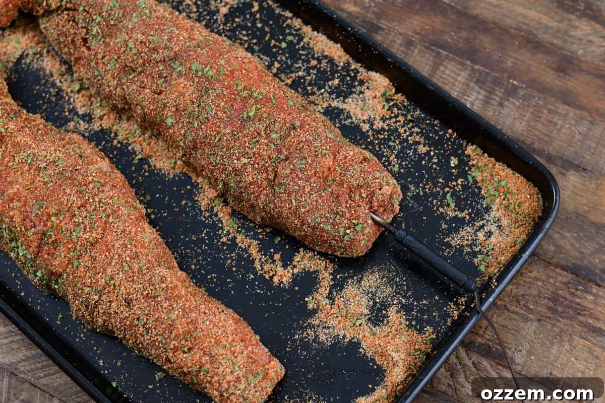 Slow-Smoked Pork Perfection 8 raw pork tenderloin with thermo probe in it