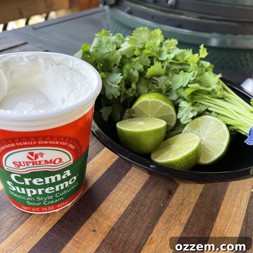 Fresh cilantro lime cream dipping sauce in a bowl, garnished with a lime wedge.