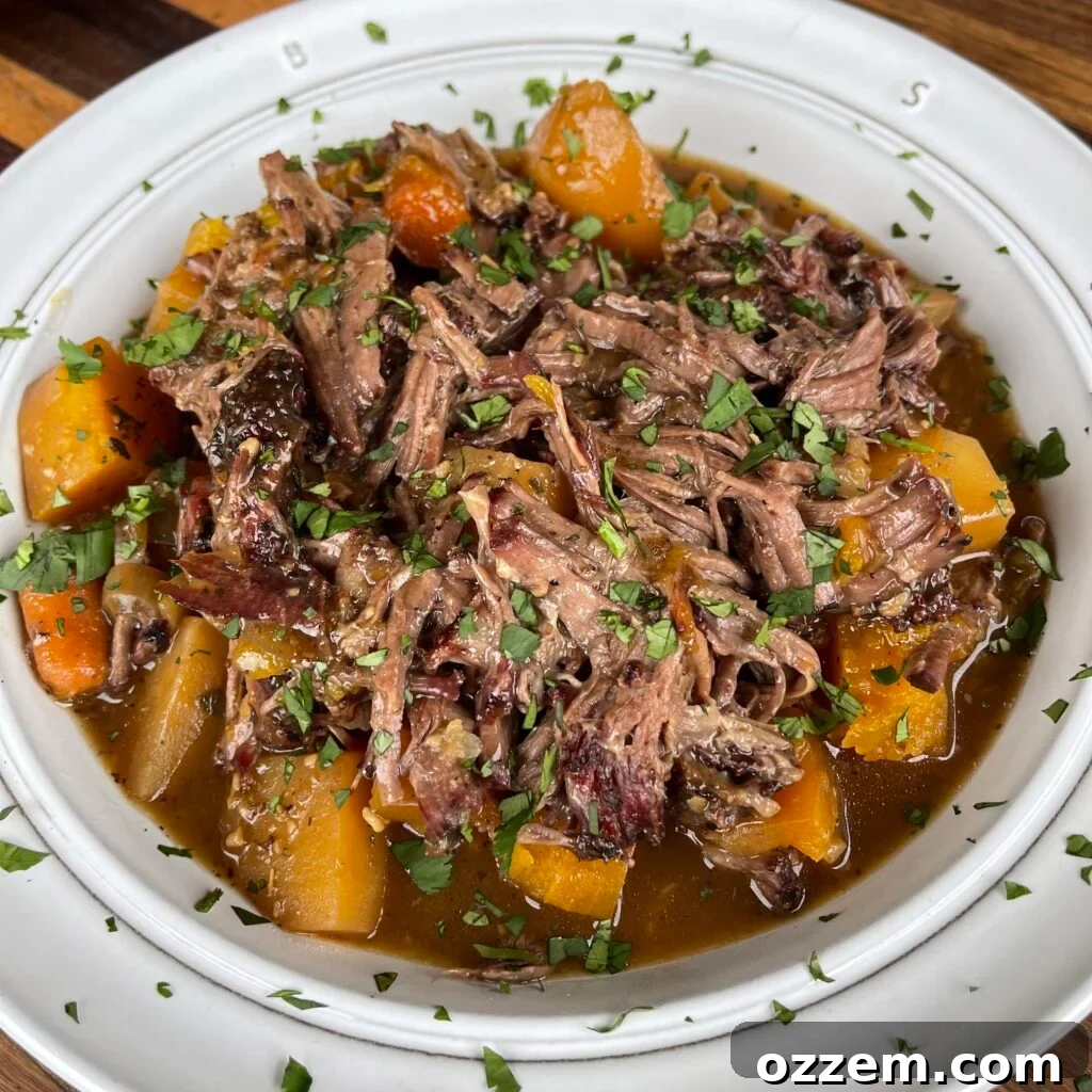 A serving of rustic pumpkin beef stew presented in an elegant white bowl, garnished with fresh herbs and a hint of cream, set against a warm, inviting backdrop.