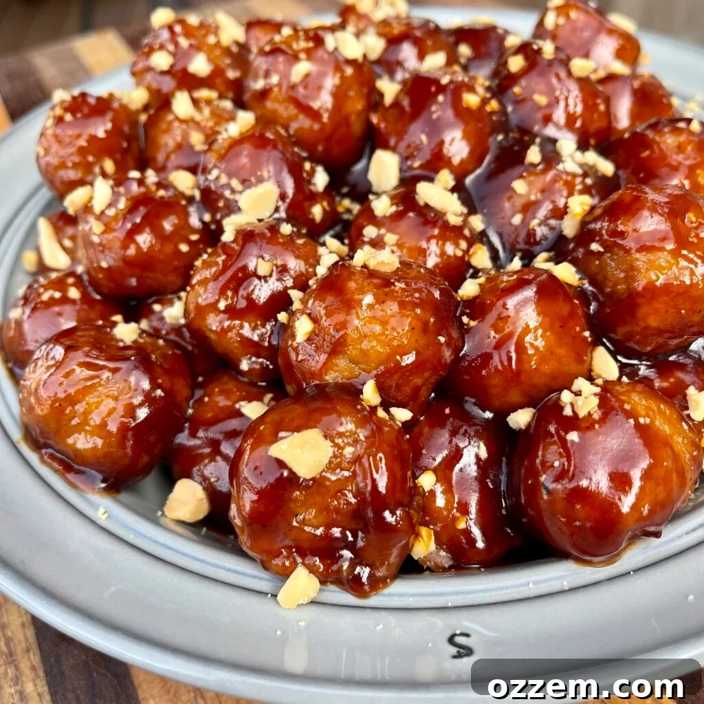 Delicious PB&J BBQ Meatballs ready to be served, garnished with crushed peanuts.