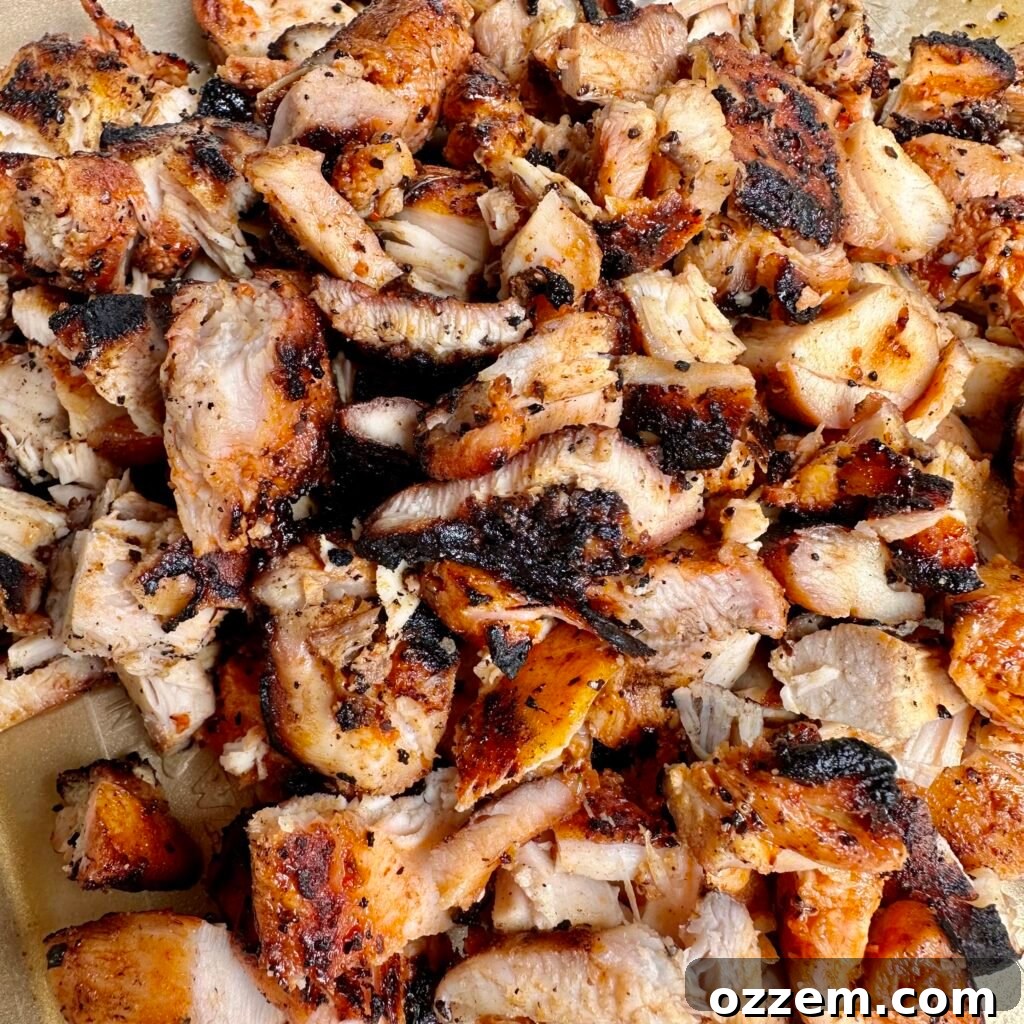 Close-up of chopped grilled chicken, ready for the enchilada filling