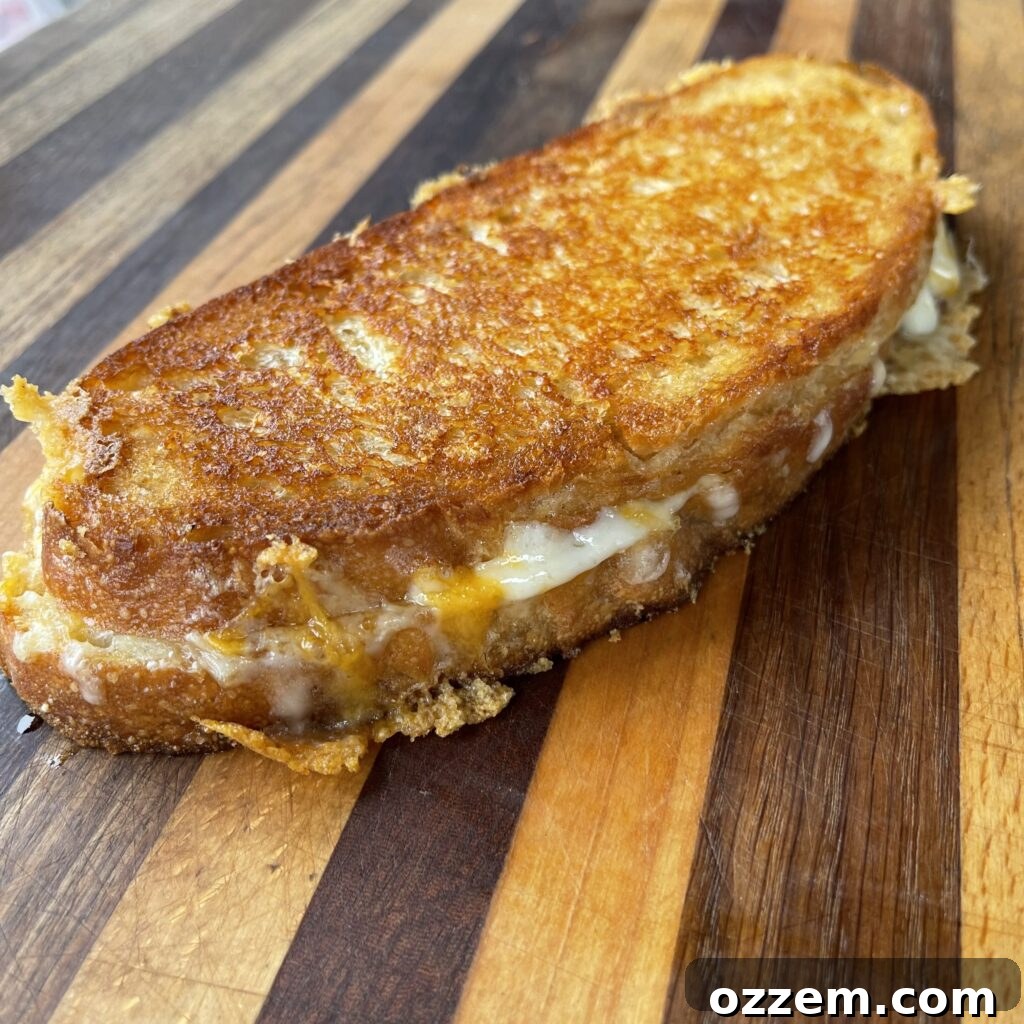 The pesto and prosciutto grilled cheese cooking on the griddle
