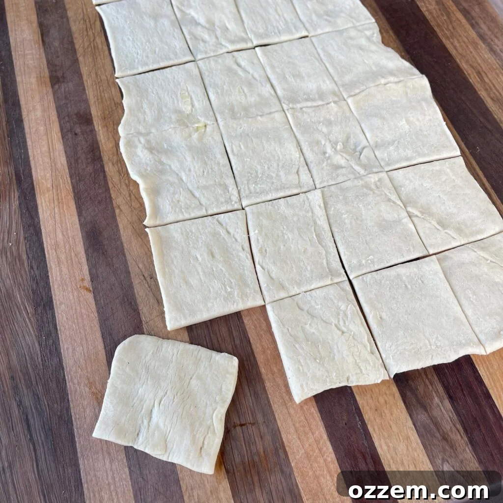 Unrolled crescent dough being prepared for cutting.