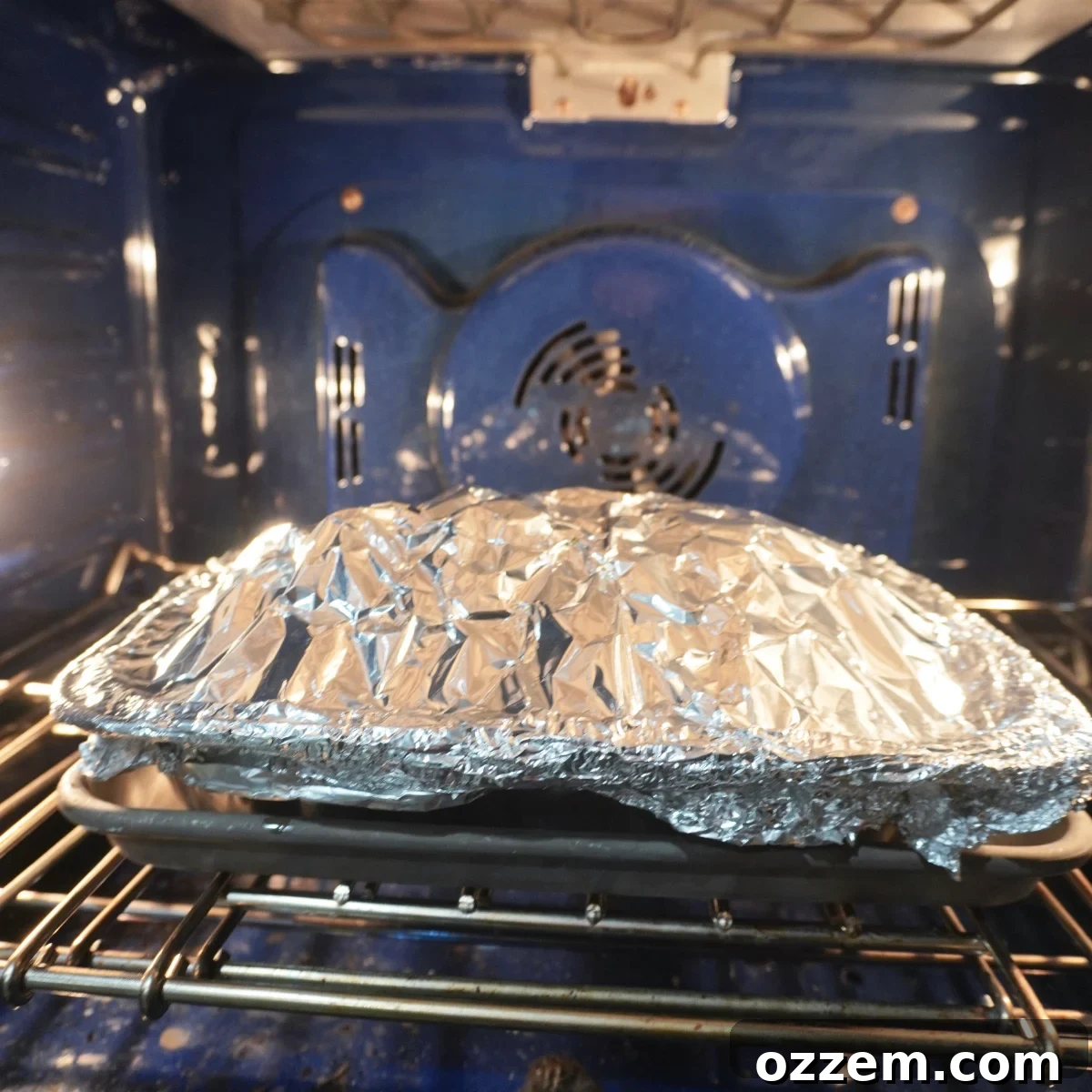 Timeless Pulled Pork Perfection 12 Classic pulled pork resting, still wrapped in foil, inside an oven.