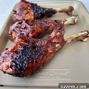 Close-up of a juicy BBQ Turkey Leg with crispy skin and savory sauce.
