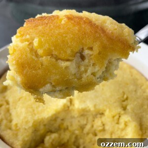 Close-up of a finished creamy corn casserole, golden and bubbly.