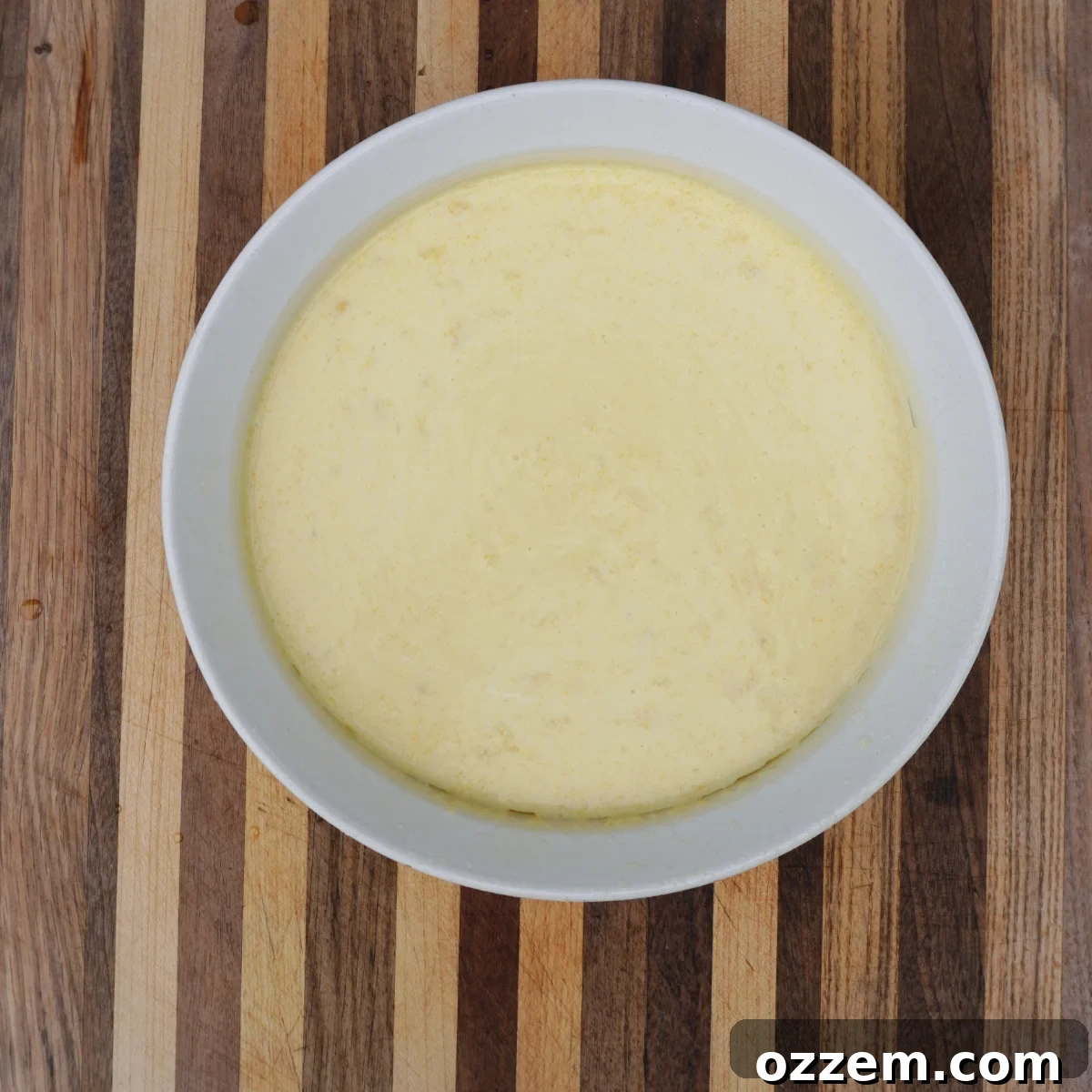 Golden Creamy Corn Bake 4 Raw creamy corn casserole mixture poured into a baking dish, ready for cooking.