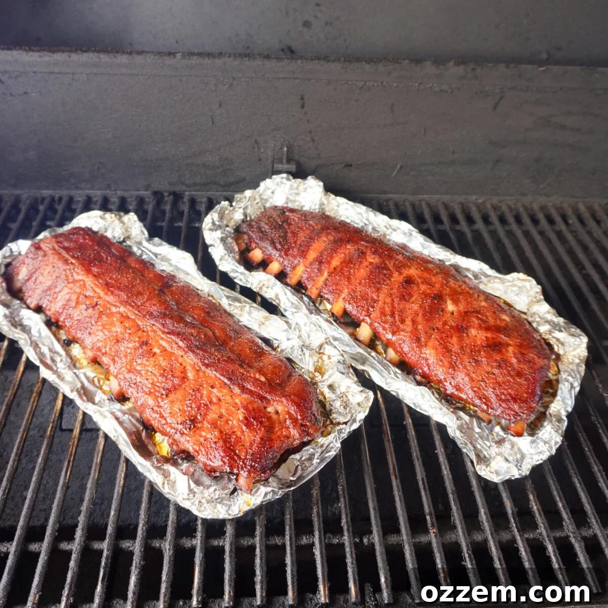 Succulent Slow-Smoked Baby Back Ribs 11 Unwrapped classic BBQ baby back ribs on the smoker, ready for saucing.