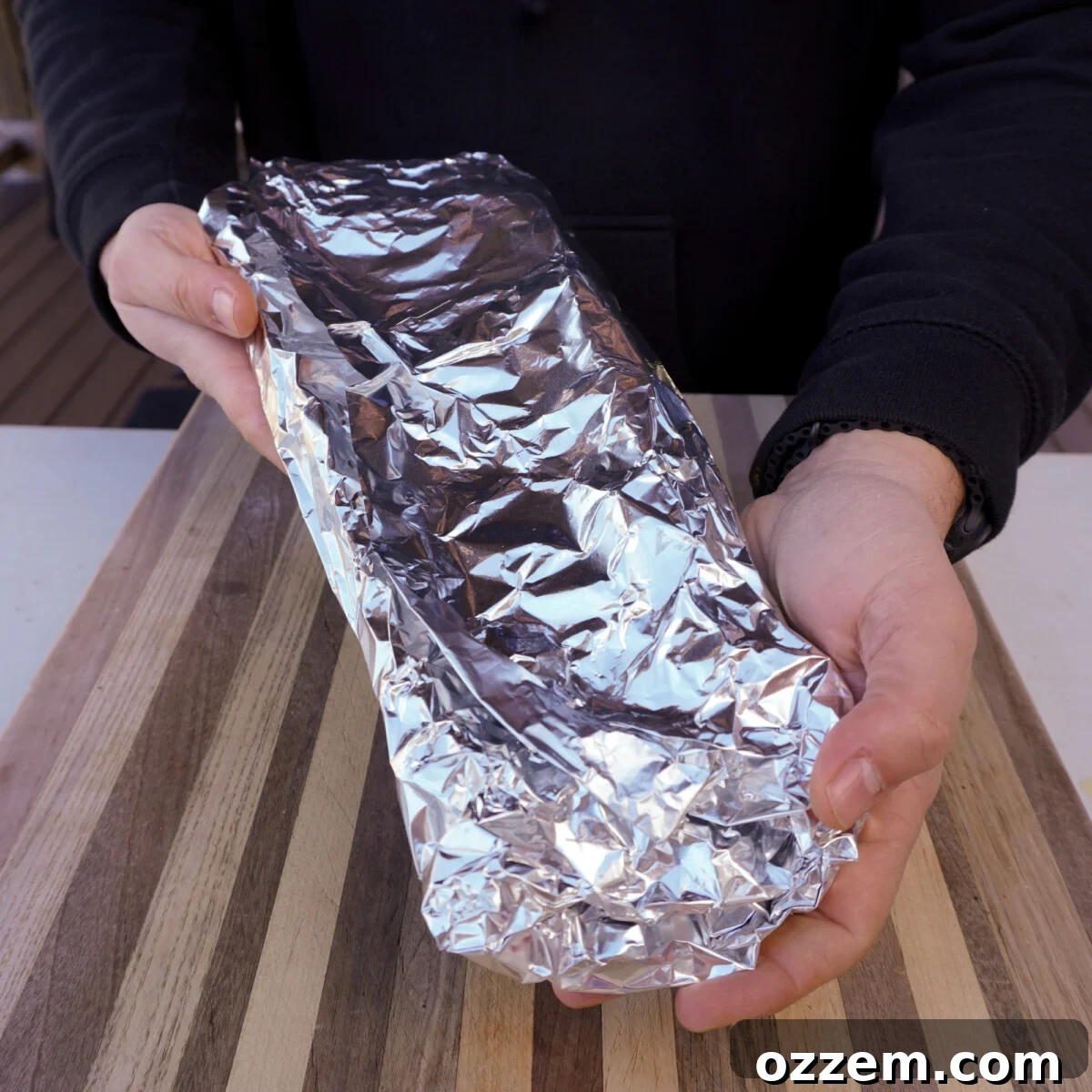 Succulent Slow-Smoked Baby Back Ribs 10 Ribs tightly wrapped in aluminum foil, ready for the next smoking phase.