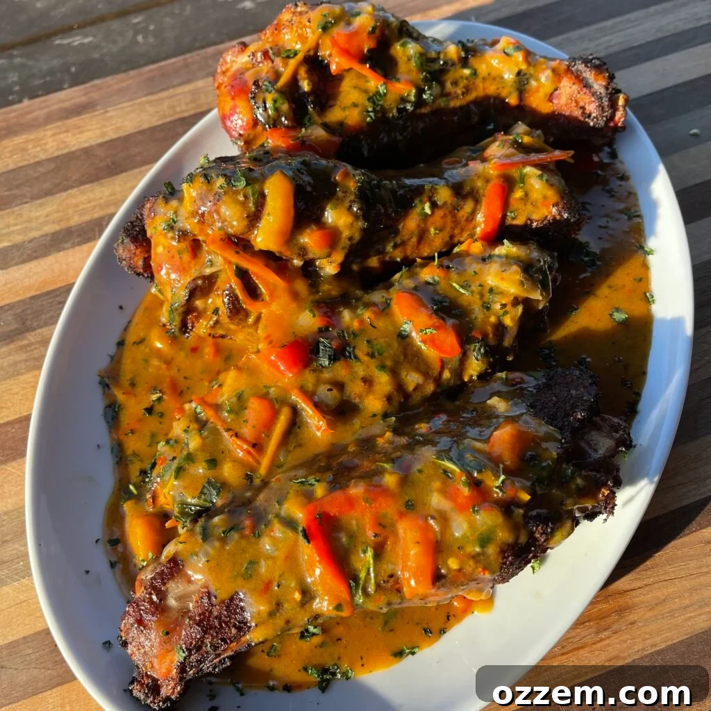 Plate of perfectly grilled smothered turkey wings with rich gravy
