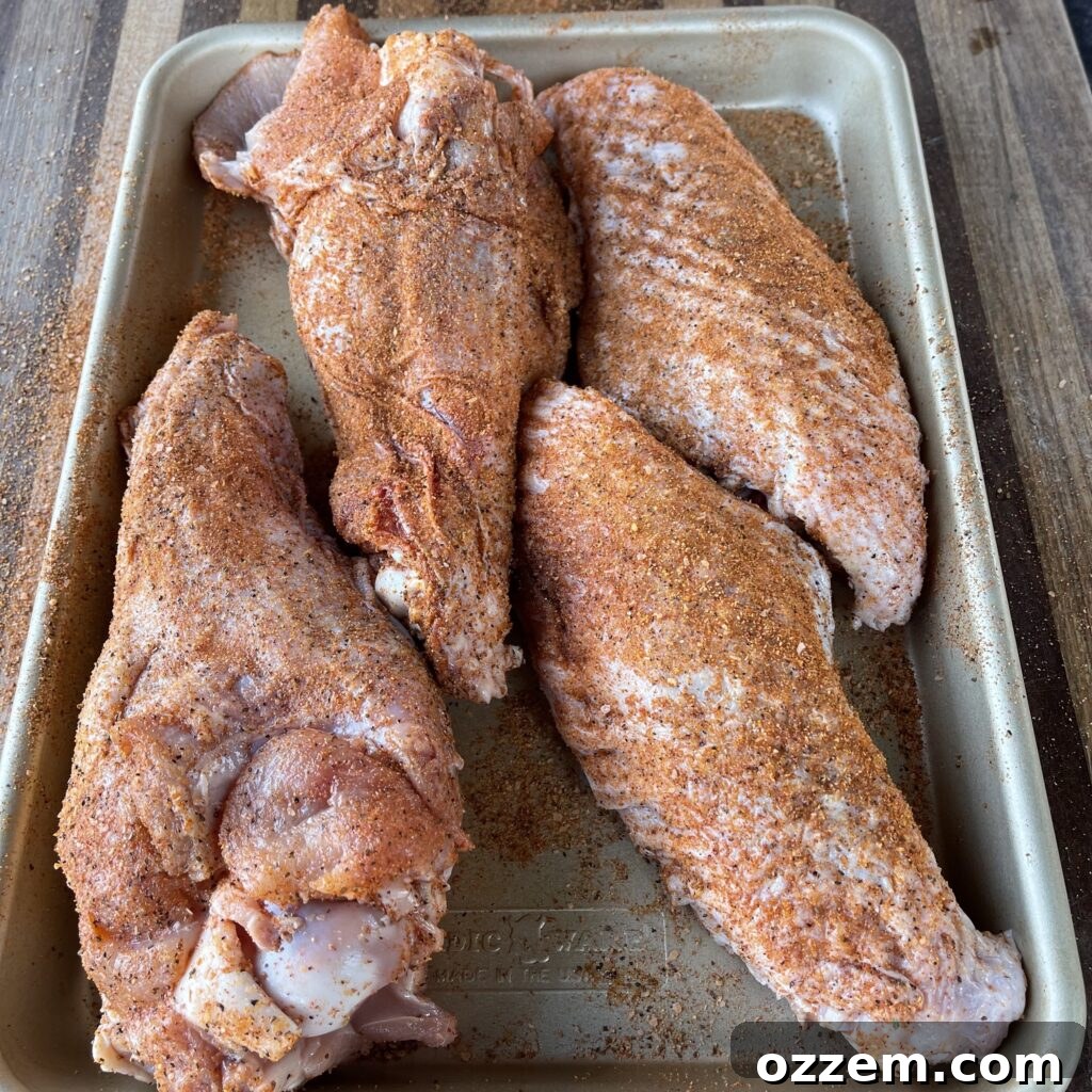 Raw turkey wings seasoned with BBQ rub and olive oil
