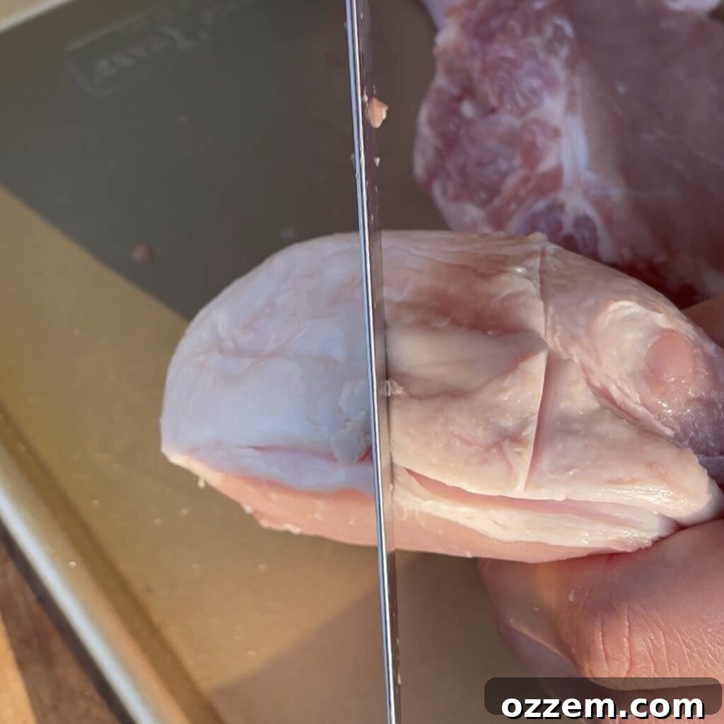 The Ultimate Juicy Pork Chops 3 Thick-cut pork chop with fat cap scored, ready for seasoning.