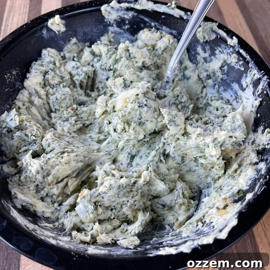 Close-up of freshly made garlic and herb compound butter in a bowl.
