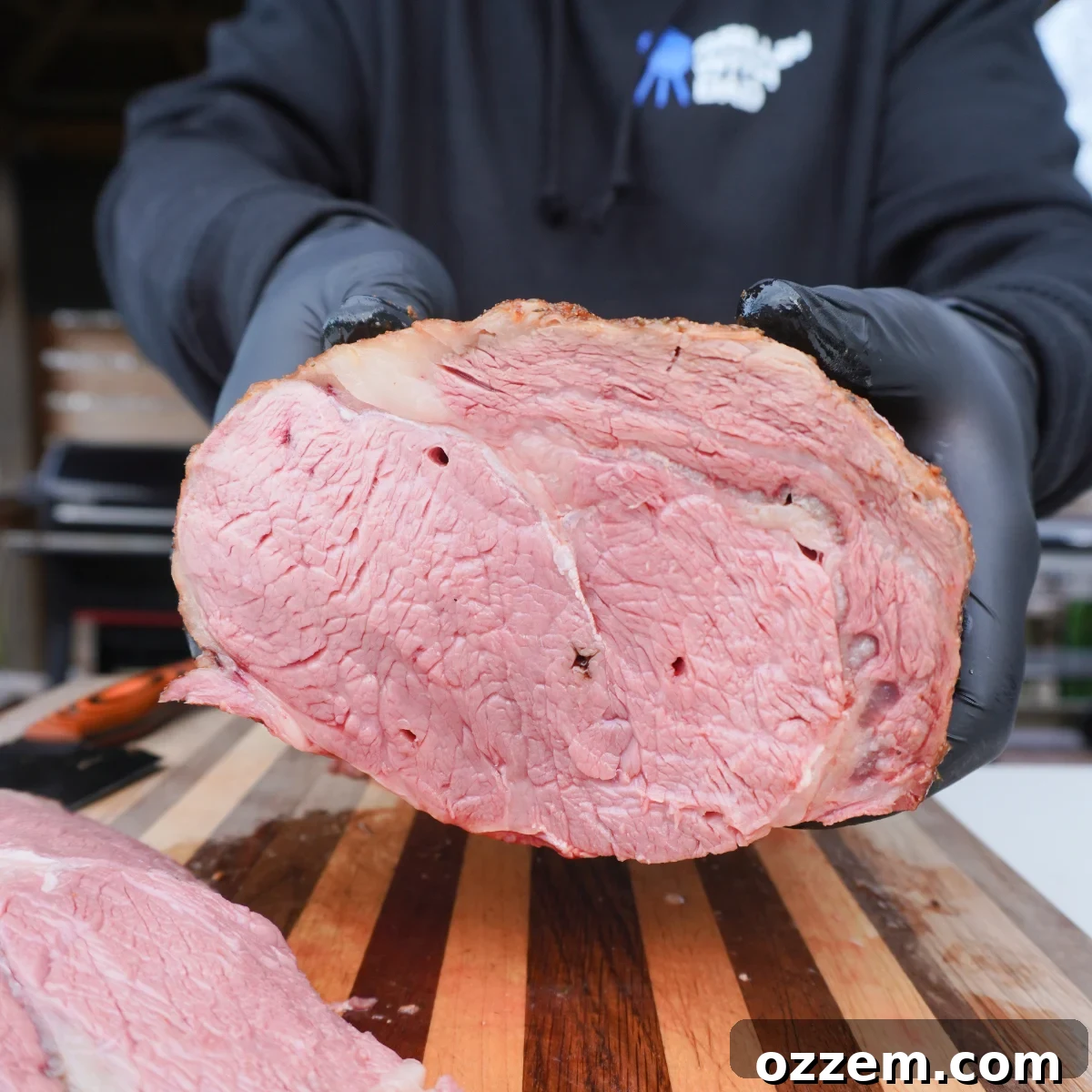 Perfect medium rare cooked prime rib sliced down the middle, revealing a juicy pink interior.