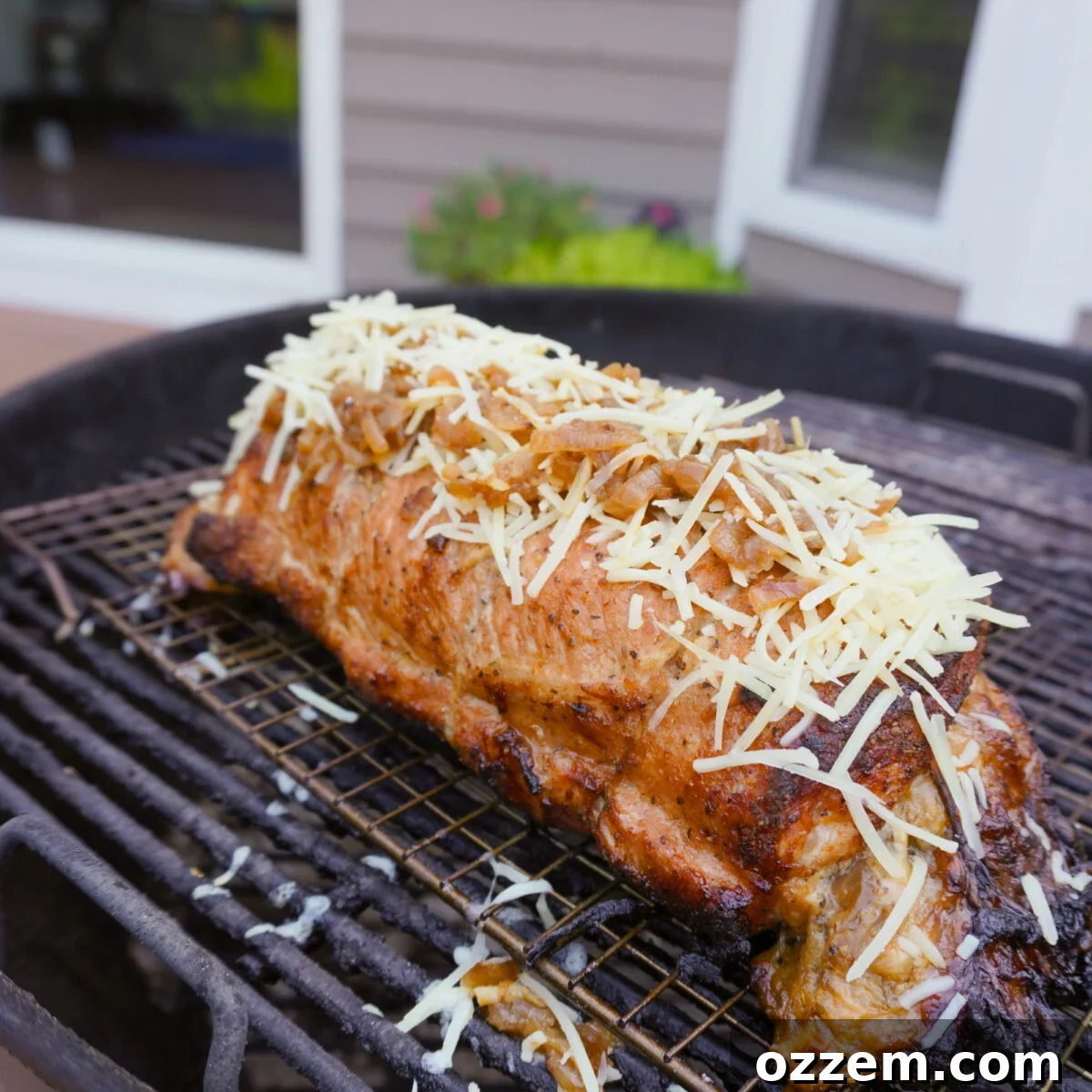 Caramelized French Onion Pork Loin 11 Grilled french onion pork loin cooking on a Weber kettle grill.