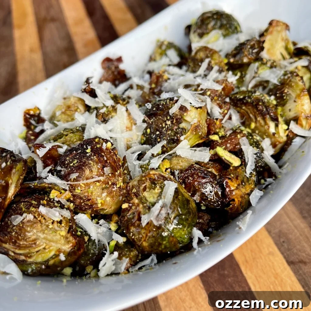 Caramelized French Onion Pork Loin 12 Air-fried Brussels sprouts plated in a deep white bowl with shredded cheese.