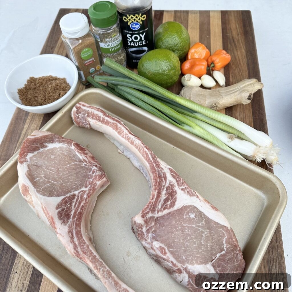 Fresh ingredients laid out for homemade jerk marinade, including habanero peppers, lime, green onion, and ginger.