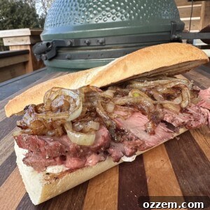 A delicious grilled tri tip sandwich, perfectly cut in half and ready to serve.