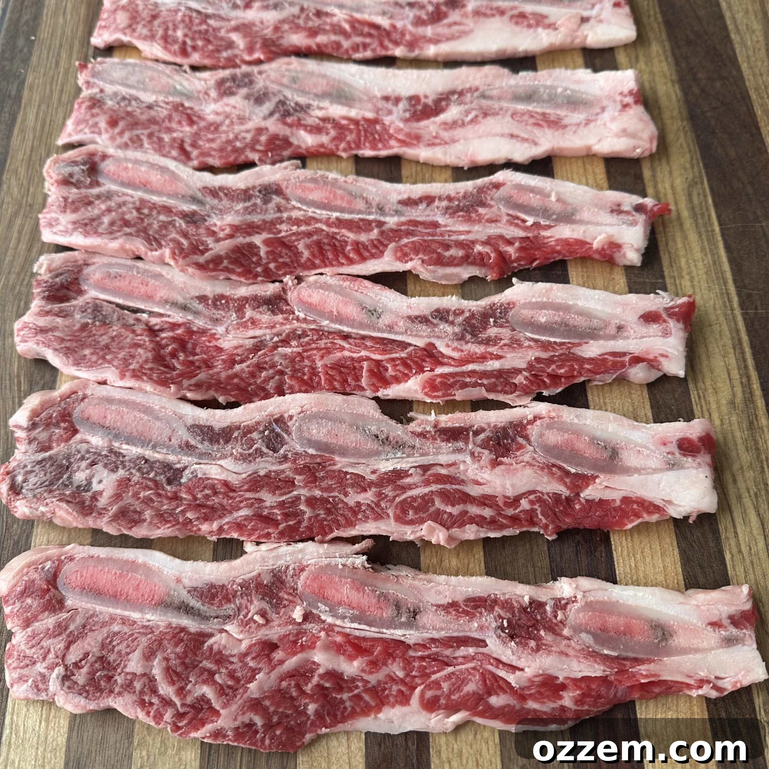 Flame-Kissed Beef Ribs 3 Thinly sliced flanken style short beef ribs, uncooked.