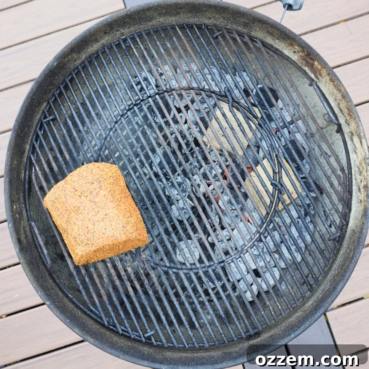 Seasoned beef roast placed on the grill grates, ready for smoking.