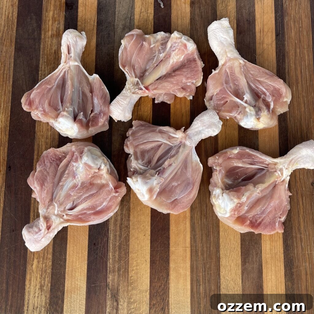 Close-up view of butterflied chicken drumsticks on a cutting board